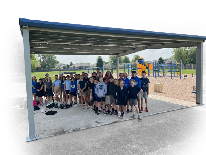 Group of kids standing underneath a park shelter